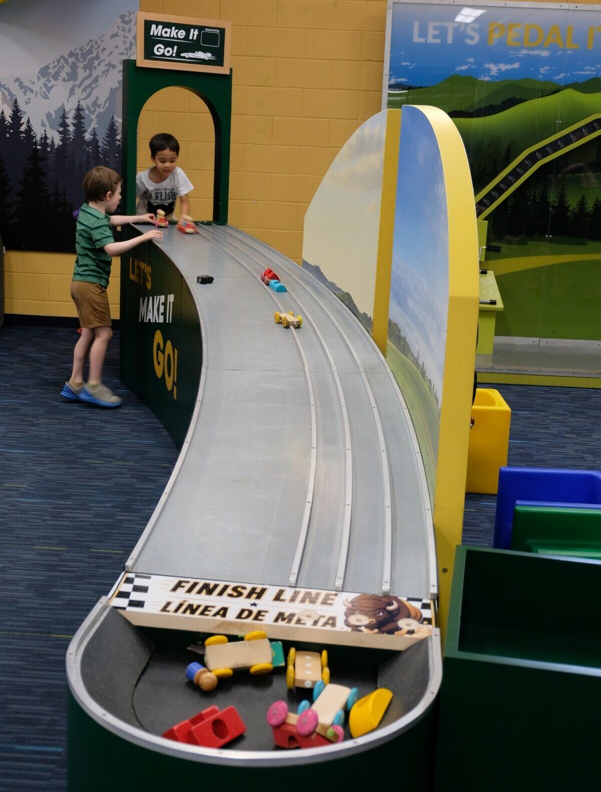 Make It Go! Make It Go car ramp with kids at the top.